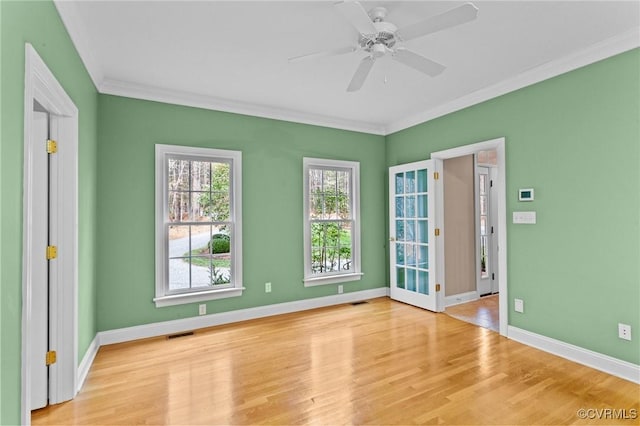 spare room featuring ceiling fan, light hardwood / wood-style flooring, and crown molding