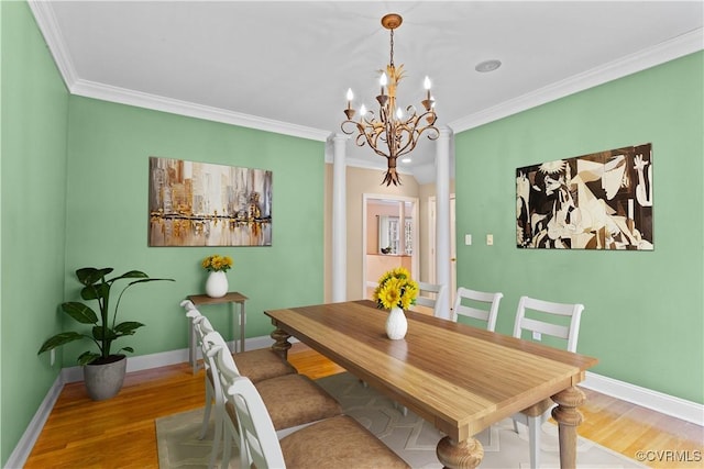 dining room featuring a chandelier, wood-type flooring, and ornamental molding