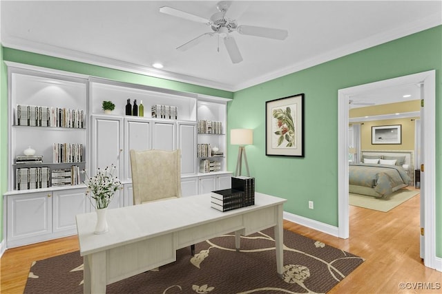 home office with ceiling fan, built in features, crown molding, and light hardwood / wood-style flooring