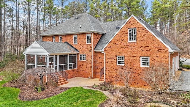 rear view of property with a patio area and a sunroom