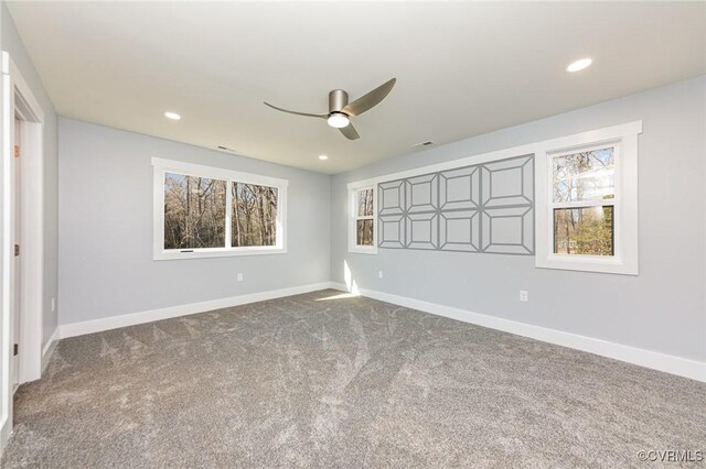 unfurnished bedroom with carpet floors, visible vents, and baseboards