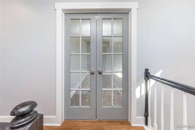 doorway to outside featuring wood finished floors and french doors
