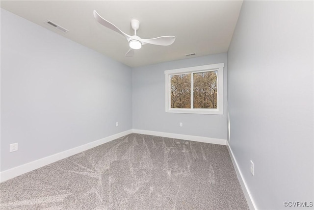 spare room with baseboards, visible vents, carpet floors, and ceiling fan
