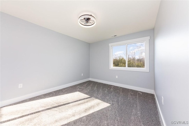 carpeted spare room with baseboards and visible vents