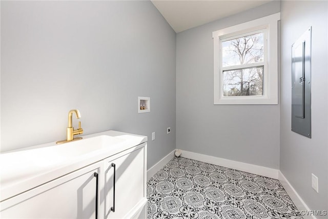 laundry area featuring a sink, hookup for a washing machine, hookup for an electric dryer, cabinet space, and baseboards