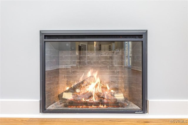 details featuring a lit fireplace