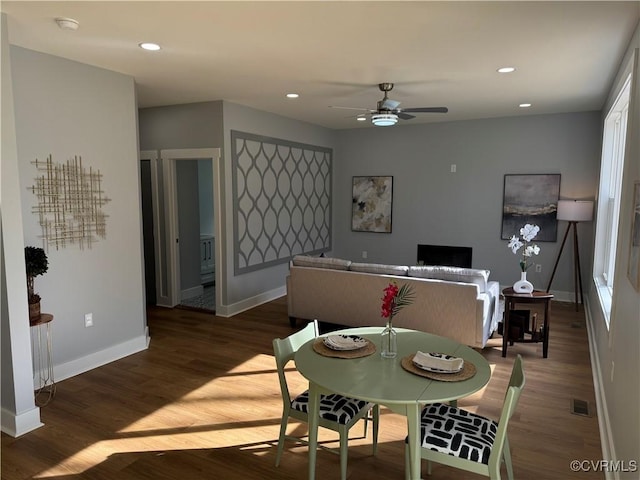 dining space with a ceiling fan, wood finished floors, baseboards, visible vents, and recessed lighting