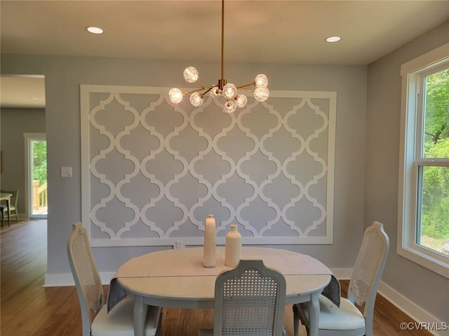dining room featuring recessed lighting, baseboards, an inviting chandelier, and dark wood-type flooring