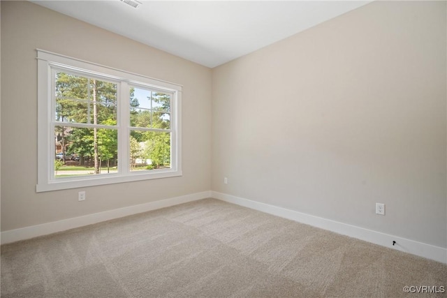 carpeted spare room with baseboards