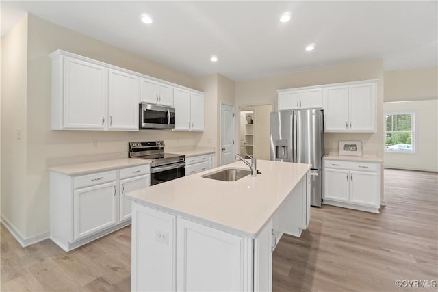 8355 Patrick Henry Blvd, Mechanicsville, VA 23116 - kitchen with appliances with stainless steel finishes, a sink, light wood-style floors, an island with sink, and light countertops