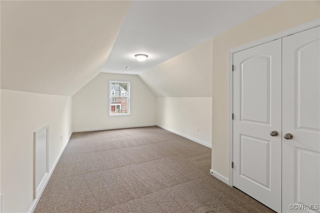 bonus room with vaulted ceiling, carpet, and baseboards