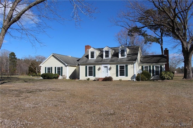 new england style home featuring a front lawn