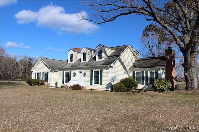 new england style home with a front lawn