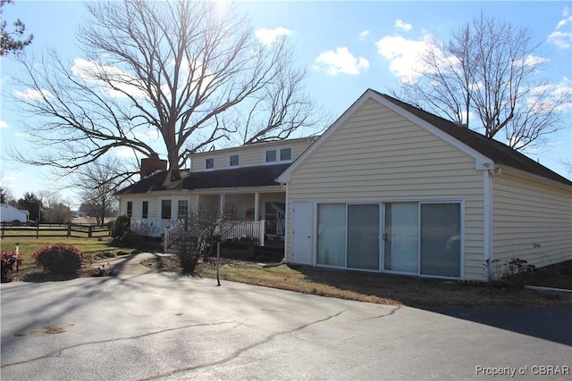 back of property with a porch