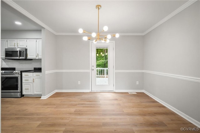 unfurnished dining area with a notable chandelier, ornamental molding, and light hardwood / wood-style floors