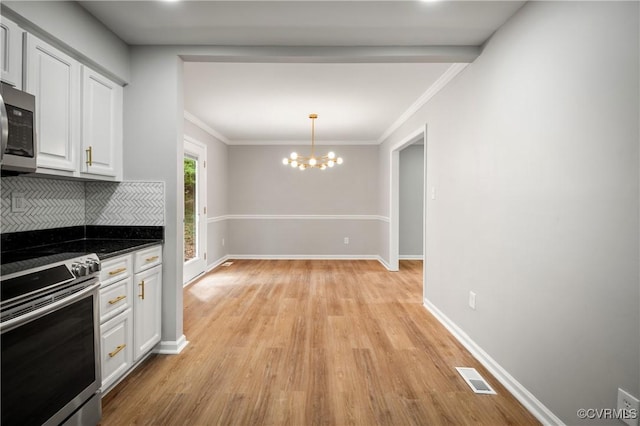 kitchen featuring an inviting chandelier, white cabinetry, stainless steel appliances, decorative backsplash, and light wood-type flooring