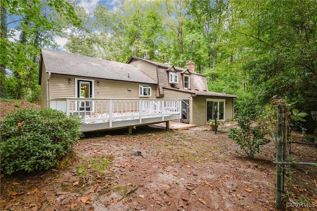 back of property featuring a wooden deck