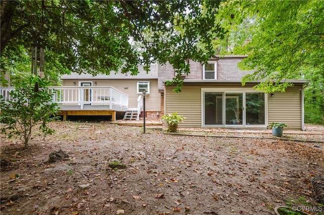 back of house featuring a wooden deck