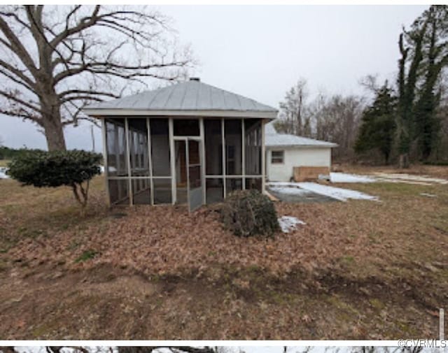 exterior space with a patio area and a sunroom