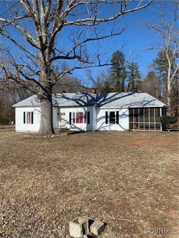 view of front of property featuring a sunroom and a front yard