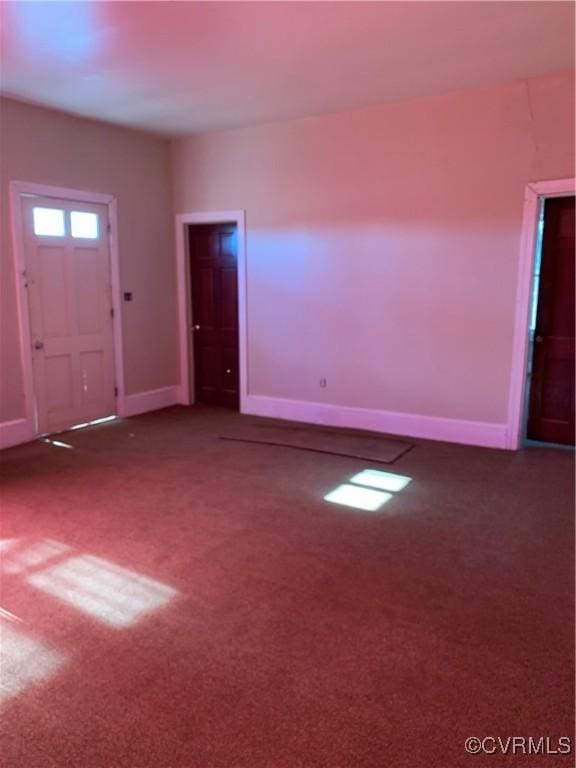 entryway featuring dark colored carpet