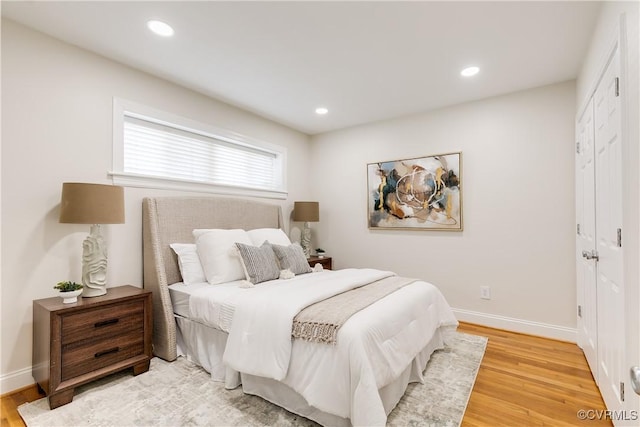 bedroom with wood-type flooring and a closet