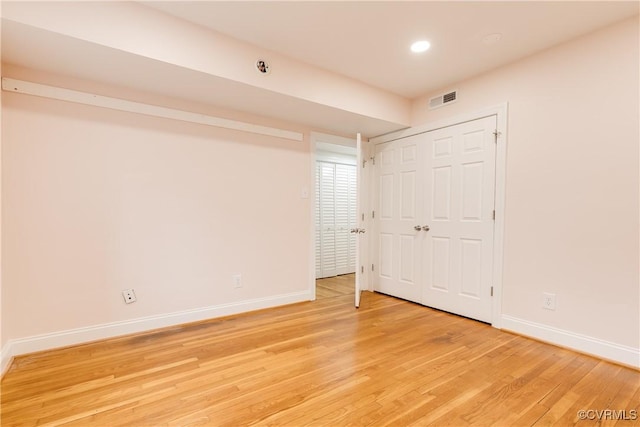 unfurnished bedroom with light hardwood / wood-style floors and a closet