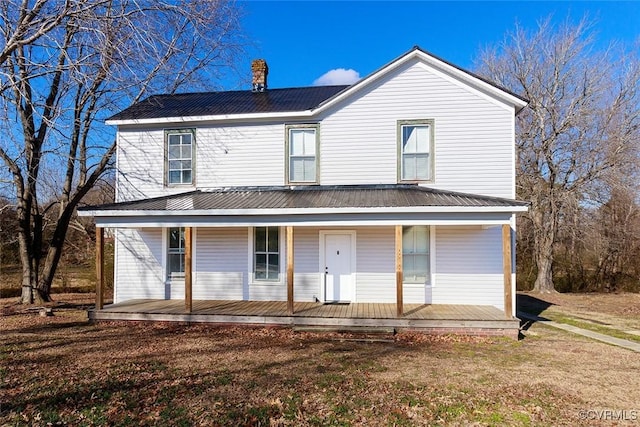 back of house with a porch and a yard