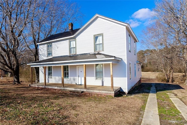 view of front facade featuring a front lawn and covered porch