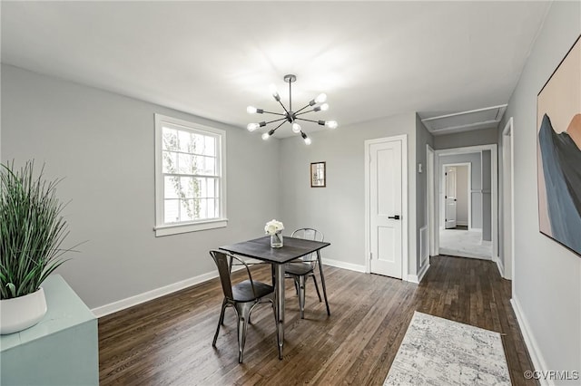 dining room featuring dark hardwood / wood-style flooring and an inviting chandelier