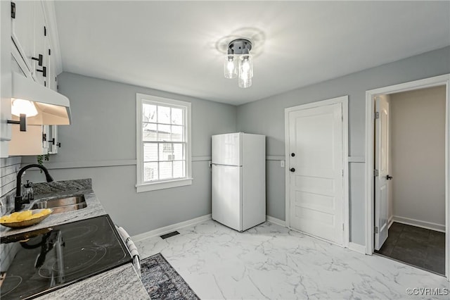 kitchen with sink, white cabinetry, white refrigerator, and range with electric cooktop