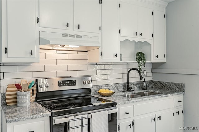 kitchen with white cabinetry, backsplash, stainless steel electric stove, light stone countertops, and sink