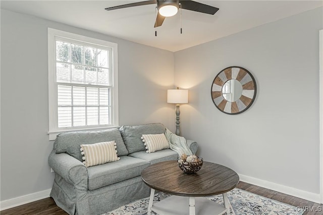 living room with dark wood-type flooring and ceiling fan