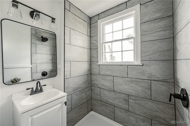 bathroom featuring vanity and tiled shower