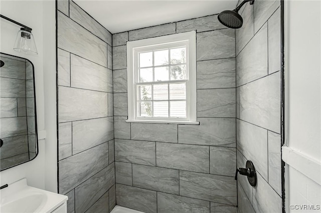 bathroom featuring vanity and a tile shower