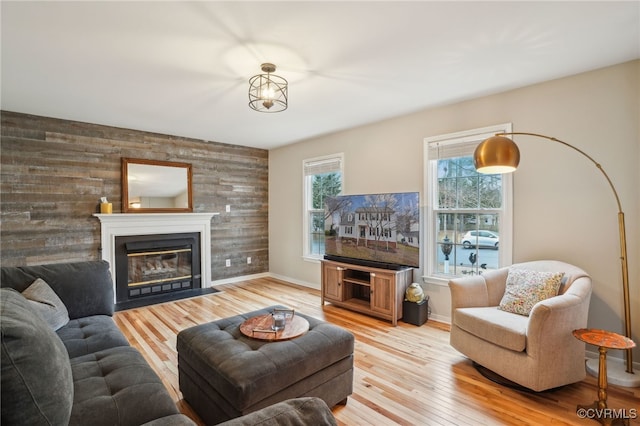 living room featuring wood-type flooring and wooden walls