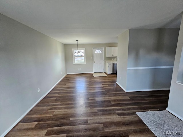 unfurnished living room with dark hardwood / wood-style floors