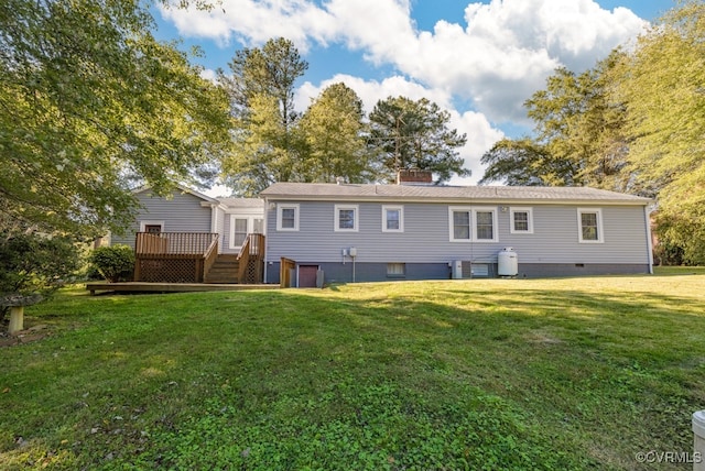 rear view of house featuring central AC unit, a deck, and a yard