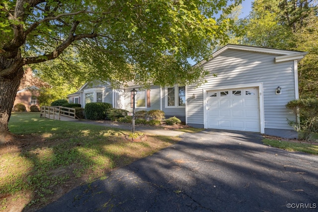 view of front facade with a front lawn and a garage