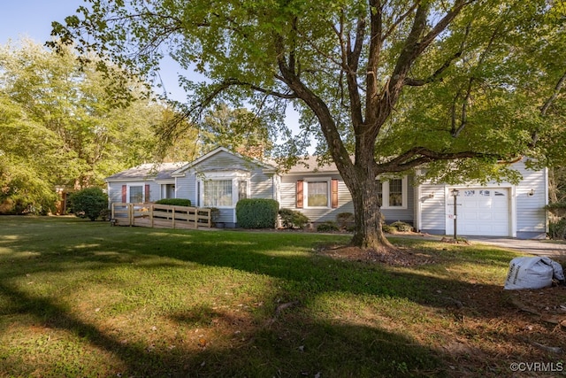 single story home featuring a front lawn and a garage