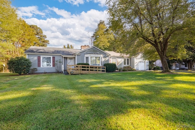 rear view of property featuring a garage and a yard