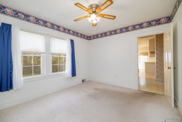 carpeted empty room with ceiling fan