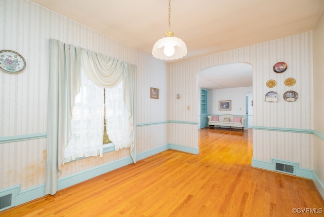 empty room with hardwood / wood-style floors