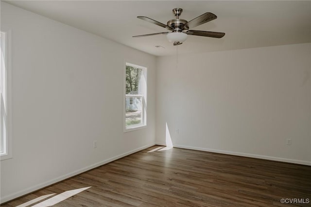 empty room featuring ceiling fan and dark hardwood / wood-style flooring