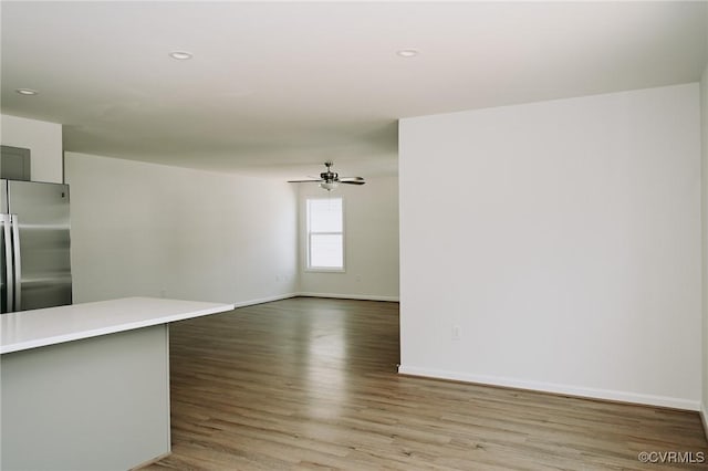 unfurnished living room with ceiling fan and hardwood / wood-style flooring