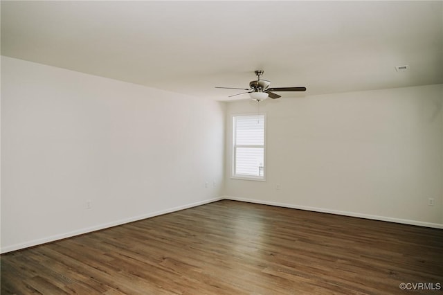 empty room featuring ceiling fan and dark hardwood / wood-style floors