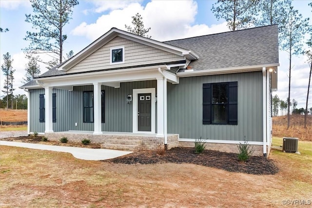 view of front of home with a porch and central air condition unit