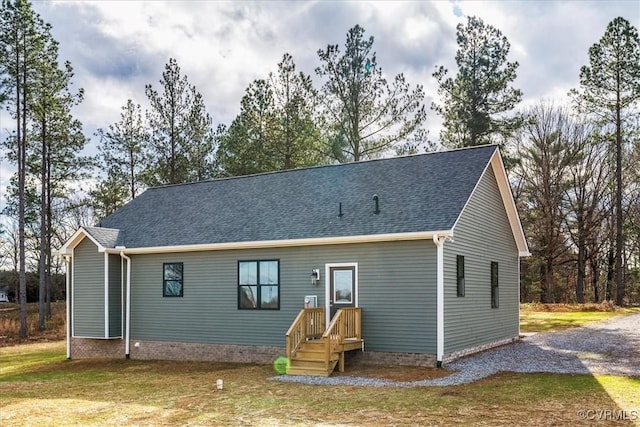 rear view of house featuring a yard