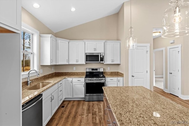 kitchen with appliances with stainless steel finishes, white cabinets, and sink