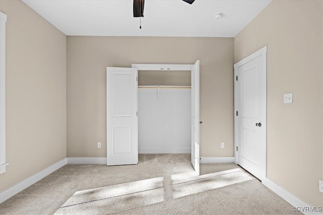 unfurnished bedroom with ceiling fan, a closet, and light carpet